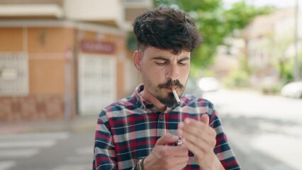 Wall Mural - Young hispanic man smoking at street