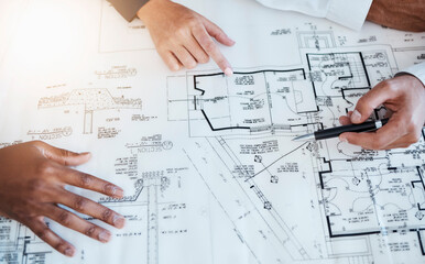 Wall Mural - Hands of architects, engineers and building construction workers planning project with blueprint in meeting at work, working on house and talking with document. Creative designer with paper at table