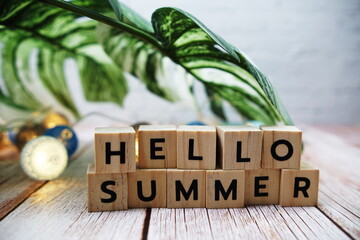 Wall Mural - hello summer alphabet letters with monstera leave and led cotton balls decoration on wooden backgrou