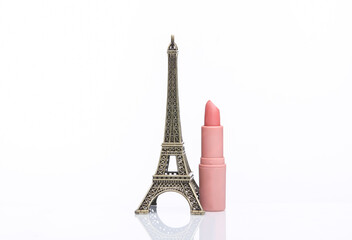 Wall Mural - Eiffel tower miniature with lipstick tube isolated on white background