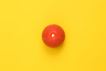 Top View Red Flaming Candle On Yellow Background
