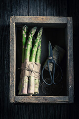 Wall Mural - Fresh green asparagus in rustic wooden box