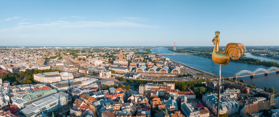 Fototapete - Beautiful aerial view of Riga city, the capital of Latvia. Aerial view of the old town of Riga and the golden cock on top of the St. Peter's Church.