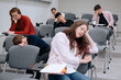 A lazy student sleeps on a desk during a boring lecture at a university or college. Fatigue from classes