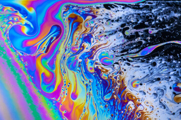 Macro photo of colourful pastel swirly patterns of a soap bubble