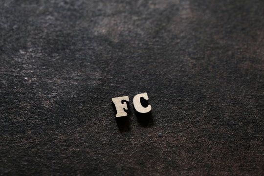 The letters F and C above the dark field. Initials FC