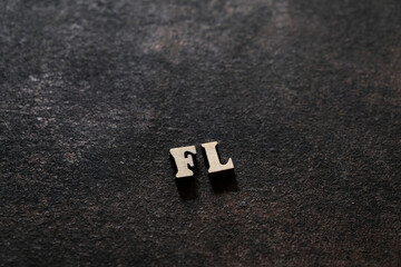 The letters F and L above the dark field. Initials FL