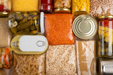 Fototapeta  - Emergency survival groceries on kitchen table closeup flat lay