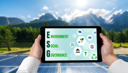 Green business transformation for environment saving and ESG business concept. Businessman using tablet to set corporate goal toward environmental friendly management and alternative clean energy use.