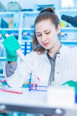 Poster - Young female laboratory assistant in laboratory analyzing environmental pollution