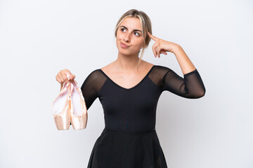 Wall Mural - Young caucasian woman practicing ballet isolated on white background having doubts and thinking