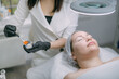 © Anna - Cosmetologist and dermatologist makes a moisturizing, rejuvenating woman lying patient in a beauty salon.