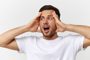 Wall Mural - Shocked excited confused tanned handsome man in basic t-shirt touch head open mouth posing isolated on over white studio background. Copy space Banner Mockup. People emotions Lifestyle concept