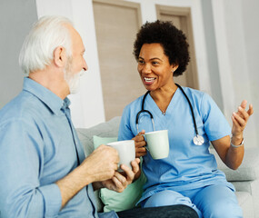 Wall Mural - nurse doctor senior care caregiver help assistence retirement home nursing elderly woman man health support african american black coffee tea drinking cup