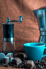 coffee maker with coffee beans and chocolates background close up