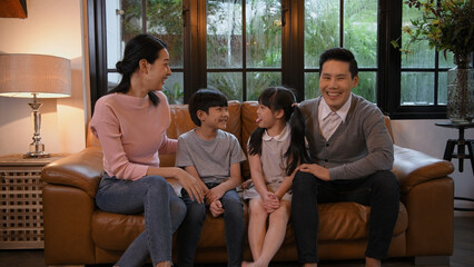 Family concept of 4k Resolution. Asian parents and children chatting together in the house.