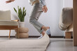canvas print picture - Woman tripping over carpet at home, closeup
