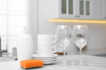 Poster - Set of clean dishes and cleaning product on table in stylish kitchen