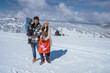© Odua Images - family portrait on snowy mountain during the day with beautiful scenery