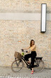 Woman with flowers in the basket of electric bike