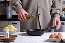 Cook Adding Olive Oil Into Frying Pan