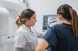 © ADDICTIVE STOCK - Female dentists examining teeth X ray on computer