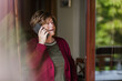© ADDICTIVE STOCK - Senior woman making call at home
