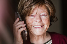 Senior Woman Making Call At Home