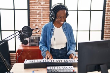 Poster - African american woman musician playing piano keyboard at music studio