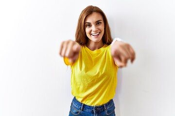 Canvas Print - Young brunette woman standing over isolated background pointing to you and the camera with fingers, smiling positive and cheerful