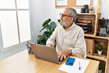 Wall Mural - Senior grey-haired man smiling confident working at office