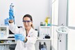 © Krakenimages.com - Young hispanic woman wearing scientist uniform using pipette at laboratory