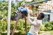 © Krakenimages.com - African american family playing on swing at playground