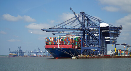 Container ship being loaded and unloaded at Felixstowe docks suffolk  England.