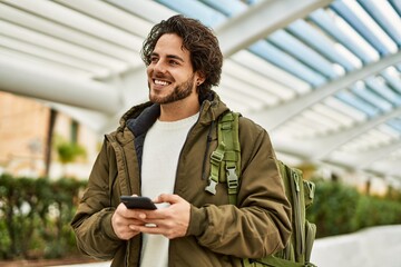 Poster - Handsome hispanic man using smartphone at the city