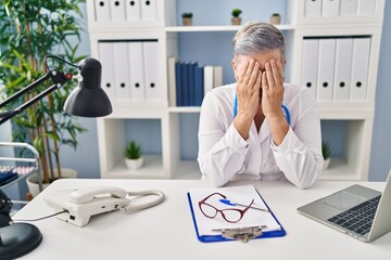 Sticker - Middle age woman wearing doctor uniform stressed working at clinic