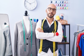 Sticker - Young bald man tailor smiling confident standing with arms crossed gesture at tailor shop