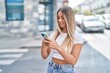 © Krakenimages.com - Young beautiful hispanic woman smiling confident using smartphone at street