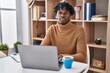 © Krakenimages.com - Young african man with dreadlocks working using computer laptop relaxed with serious expression on face. simple and natural looking at the camera.