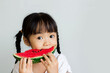 asian child eat red watermelon on white background