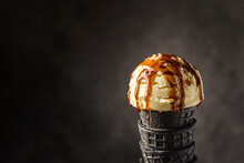 Ice Cream In A Black Cone With Caramel