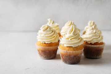Wall Mural - Vanilla cupcakes close up on white background