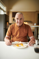 Senior Man Eating Fried Eggs