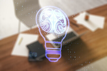 Poster - Creative light bulb with human brain hologram and modern desk with computer on background, artificial Intelligence and neural networks concept. Multiexposure