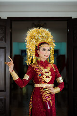 Wall Mural - A female model who wears make-up and a traditional wedding dress or attire. Traditional clothing of Bali - Indonesia. Balinese Culture