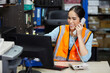 © offsuperphoto - factory worker speaking on the telephone and looking at computer monitor in the office or warehouse storage