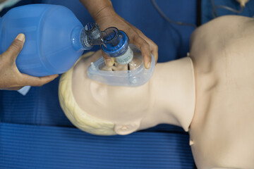 Wall Mural - Demonstrating CPR (Cardiopulmonary resuscitation) training medical procedure on CPR doll in the class.Doctor and nurse students are learning how to rescue the patient.First aid for safe life concept.