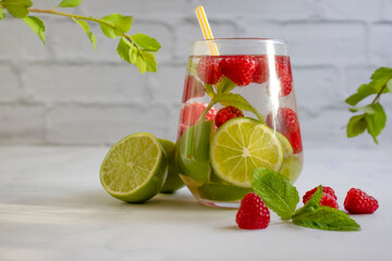 Canvas Print - Glass with lime, raspberries, mint on a light background