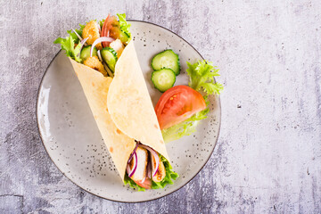 Poster - Mexican tortilla wraps with  vegetables and chicken on a plate on the table. Top view. Closeup