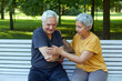 © Alex Tihonov - Elderly man got injured arm during stroll with wife outdoor